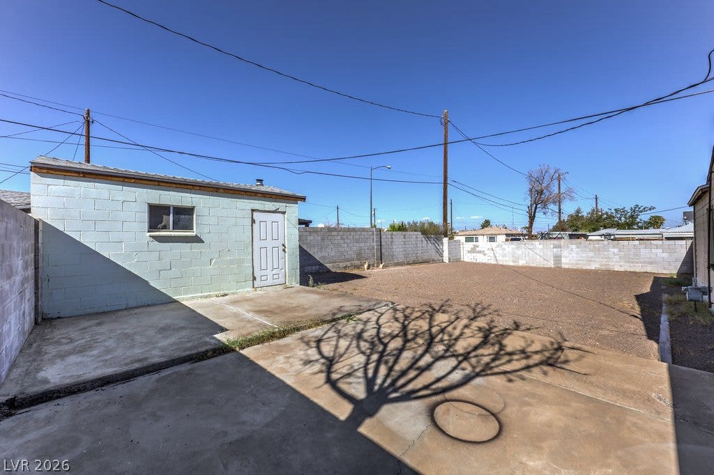 580 Karen Way, Henderson, NV 89015 A spacious backyard area includes concrete patio sections and a concrete block outbuilding.
