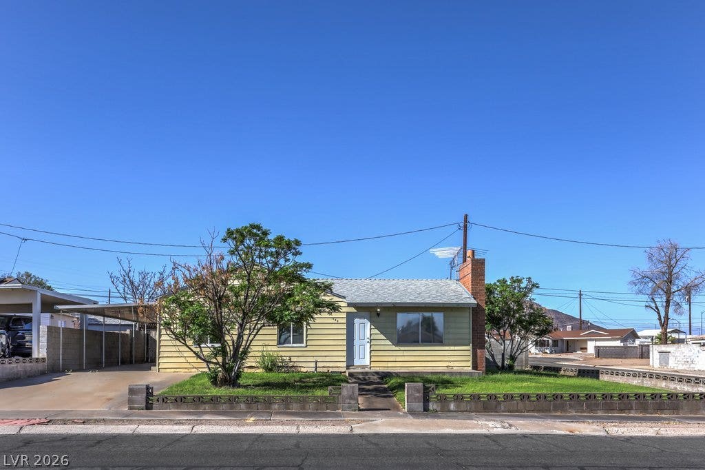 580 Karen Way, Henderson, NV 89015 A classic ranch exterior with clean horizontal siding sits beneath a clear desert sky.