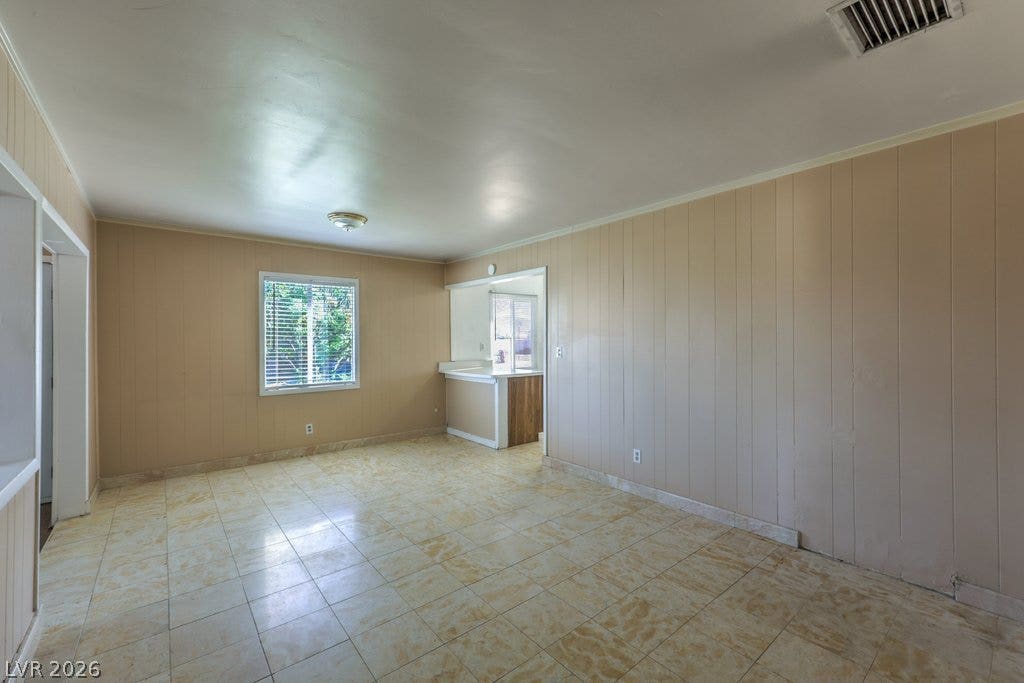 580 Karen Way, Henderson, NV 89015 Tiled flooring spans this versatile room featuring classic paneled walls and garden views.