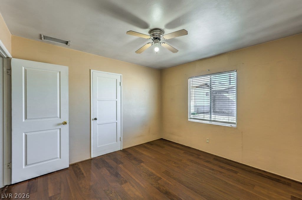 580 Karen Way, Henderson, NV 89015 Rich wood flooring anchors this versatile bedroom featuring a bright window.