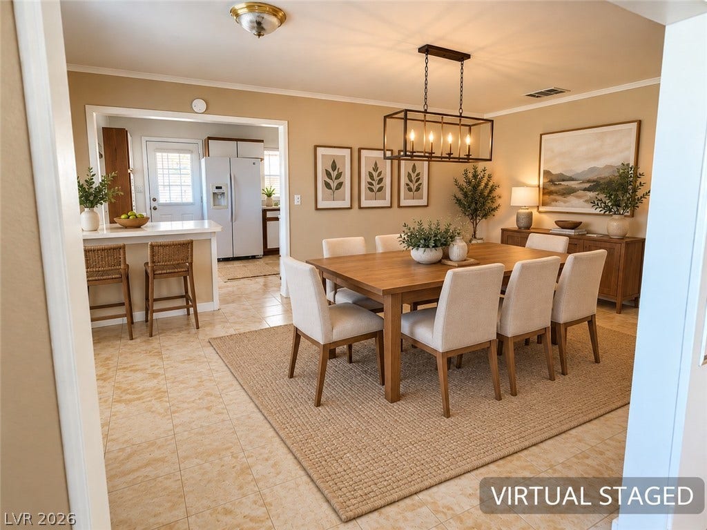 580 Karen Way, Henderson, NV 89015 Virtual Staged Photo. Crown molding highlights the open layout transitioning seamlessly from dining area to kitchen.