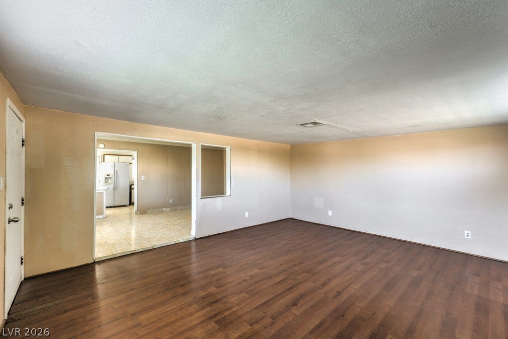580 Karen Way, Henderson, NV 89015 Rich wood flooring grounds this open living space with direct views into the kitchen.