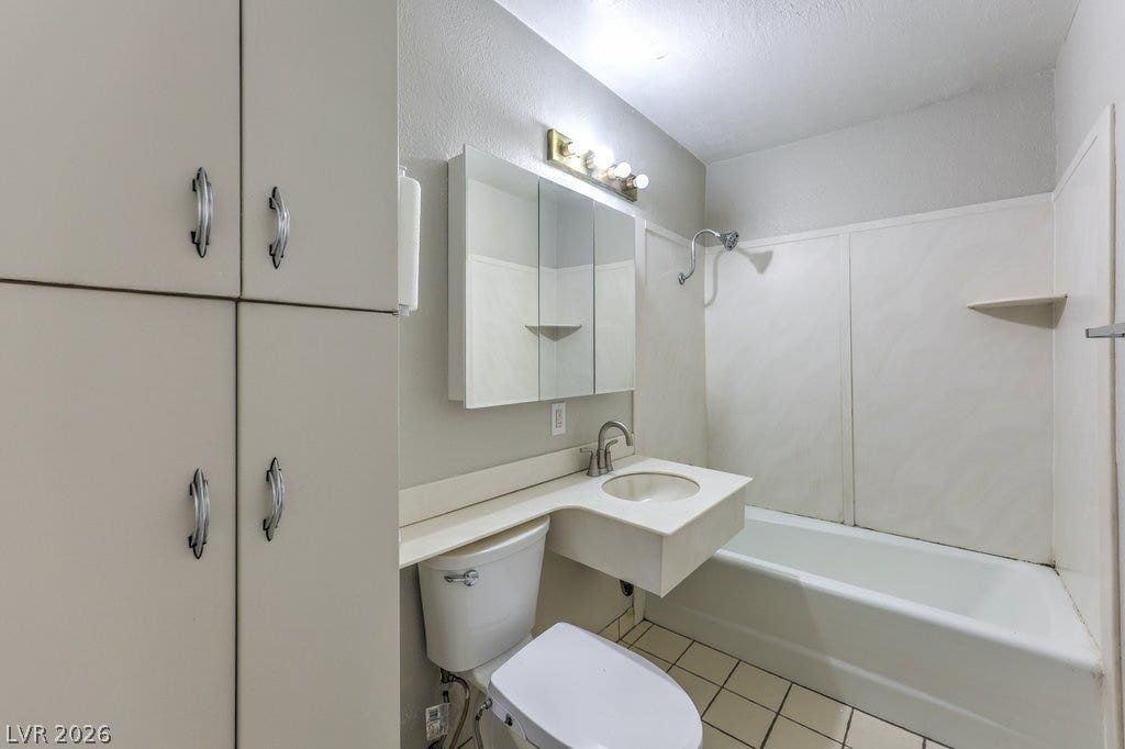 580 Karen Way, Henderson, NV 89015 Functional bathroom design incorporates built-in cabinetry and a combined tub and shower layout.