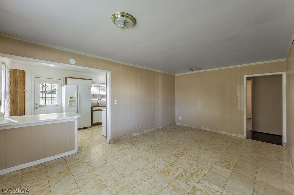 580 Karen Way, Henderson, NV 89015 An open floor plan connects the tiled living space directly to the kitchen area.