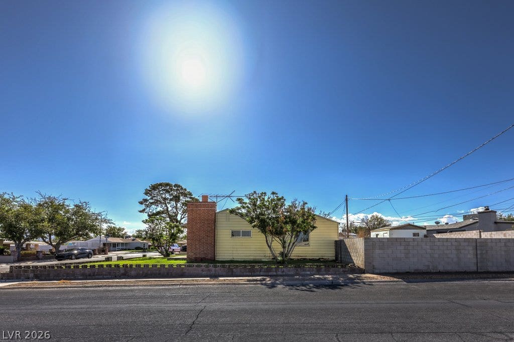 580 Karen Way, Henderson, NV 89015 A classic brick chimney accentuates the side exterior of this single-story home.