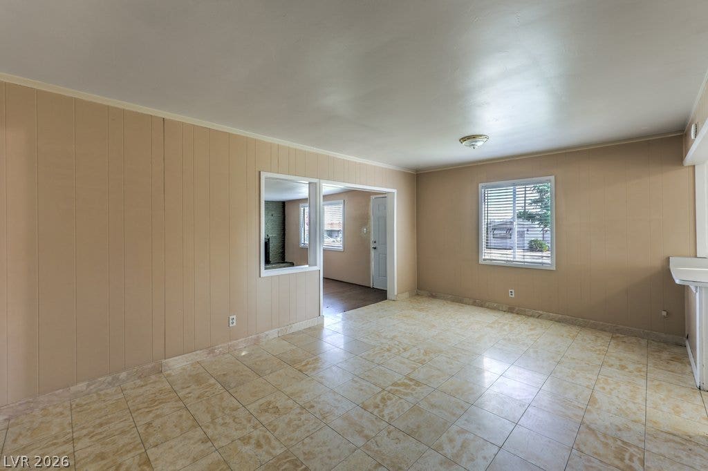 580 Karen Way, Henderson, NV 89015 Tiled flooring and classic wood paneling define this versatile living space.