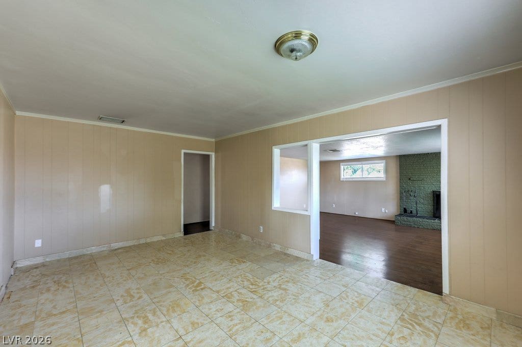580 Karen Way, Henderson, NV 89015 An open doorway connects the tiled living space to a second room featuring wood flooring.
