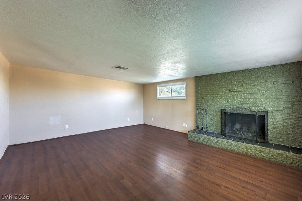 580 Karen Way, Henderson, NV 89015 Rich wood flooring anchors this spacious interior anchored by a textured brick fireplace.
