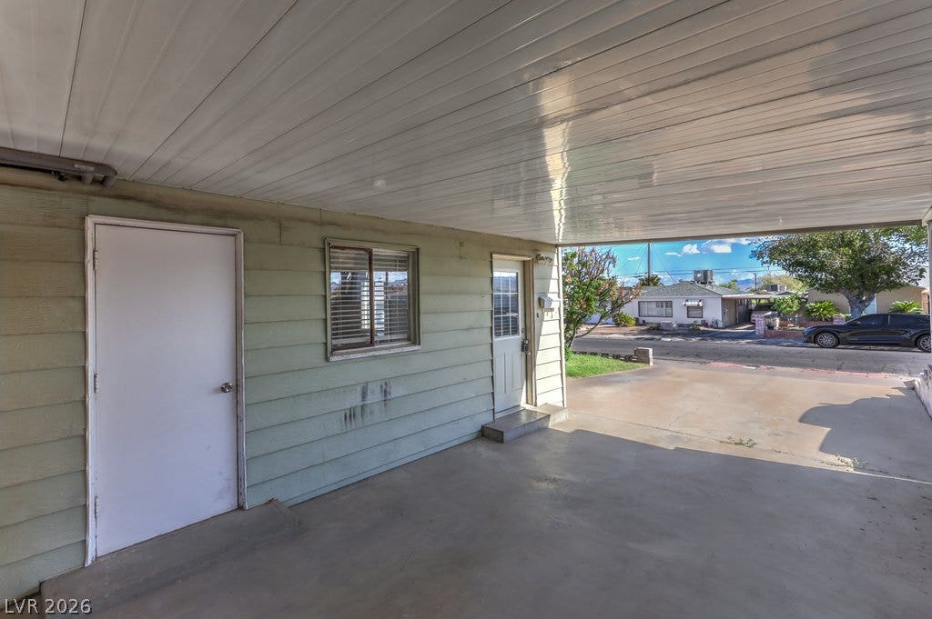 580 Karen Way, Henderson, NV 89015 A covered concrete carport provides sheltered parking and outdoor utility access.