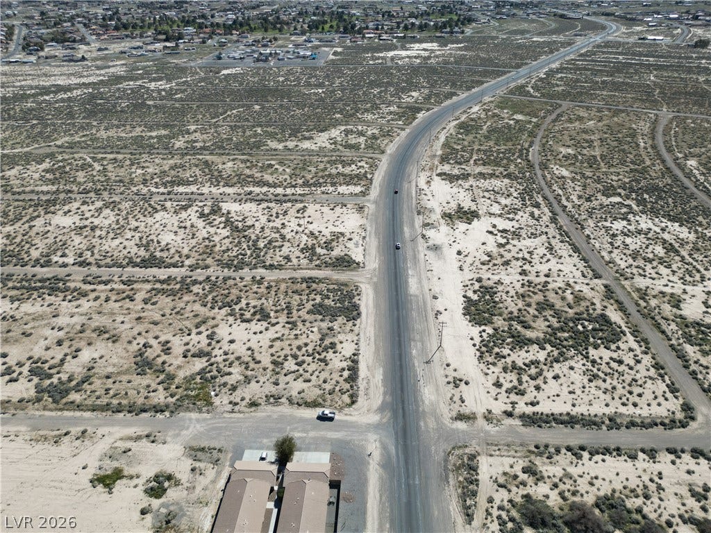2120 S Pahrump Valley Boulevard, Pahrump, NV 89048 Vast desert parcels flank a paved road, offering expansive potential in a developing area.