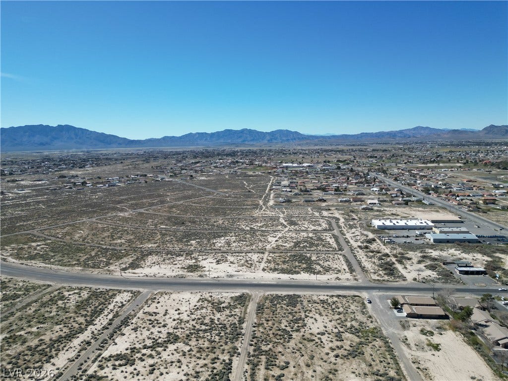 2120 S Pahrump Valley Boulevard, Pahrump, NV 89048 Expansive desert views stretch toward the distant mountains under a clear blue sky.