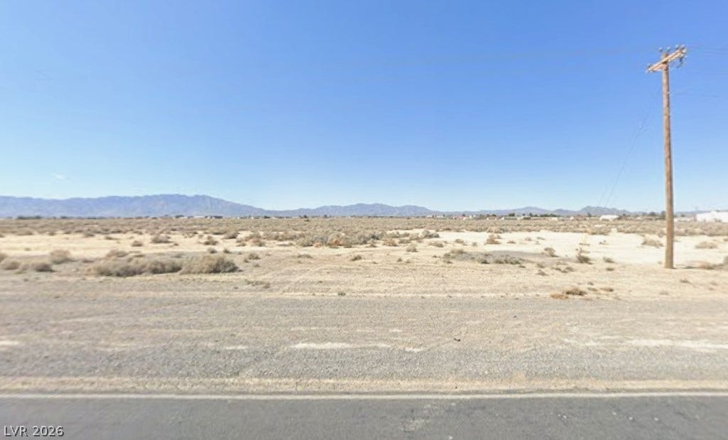 2120 S Pahrump Valley Boulevard, Pahrump, NV 89048 Distant mountain ranges frame the wide desert horizon under clear blue skies.