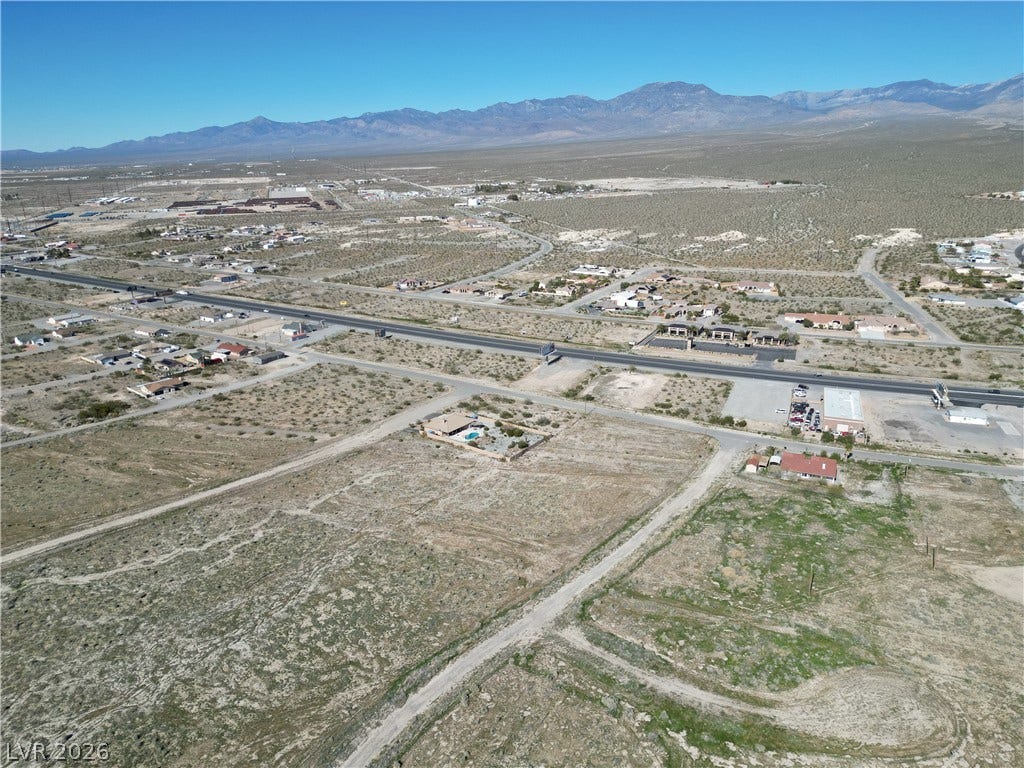 2321 S Council Court, Pahrump, NV 89048 A vast desert landscape stretches toward towering mountains under a clear blue sky.