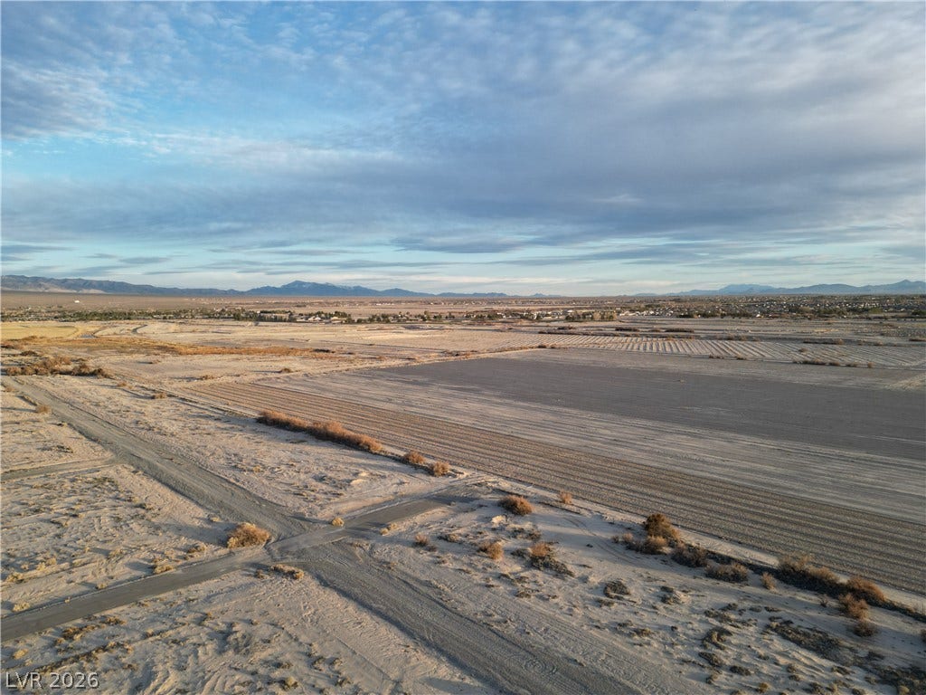 Vast desert acreage offers endless possibilities under open skies with distant mountain views.
