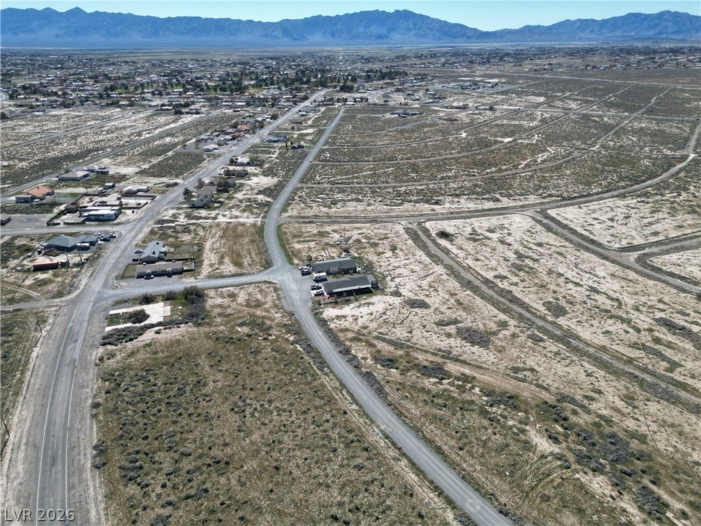 Expansive desert vistas stretch toward majestic mountain ranges in the distance.