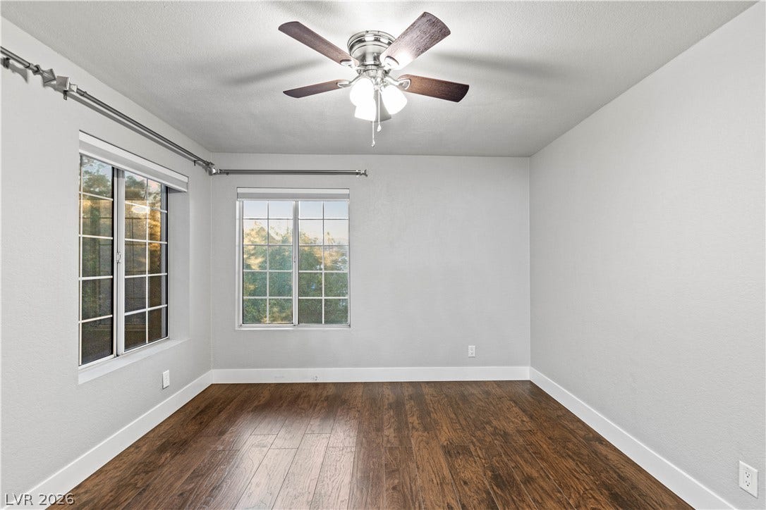 Gleaming hardwood floors and generous windows elevate this inviting space.