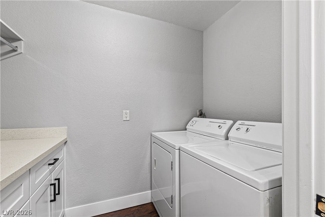 Functional workspace highlights this dedicated utility room with built-in cabinetry and durable flooring.