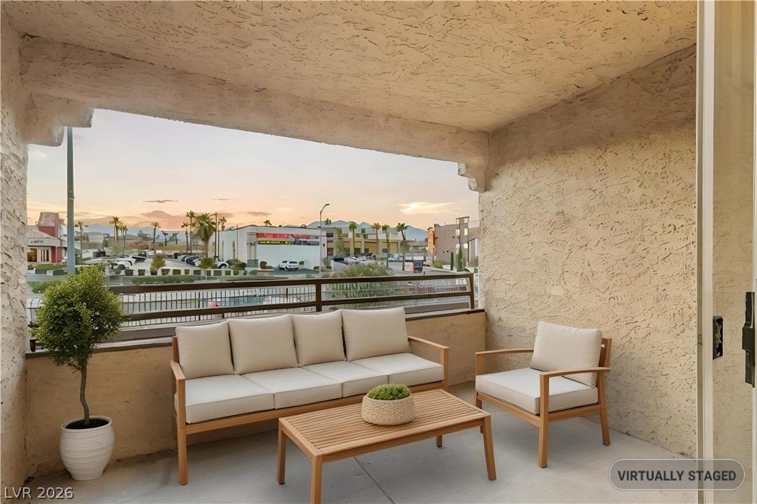**Virtually Staged** Covered balcony looks out over the surrounding neighborhood under beautiful sunset skies.