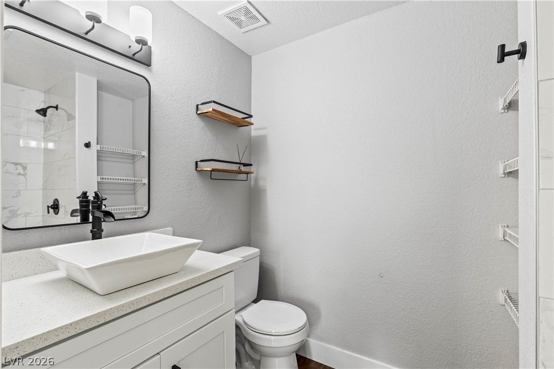 Modern fixtures and clean lines define this updated half bath.
