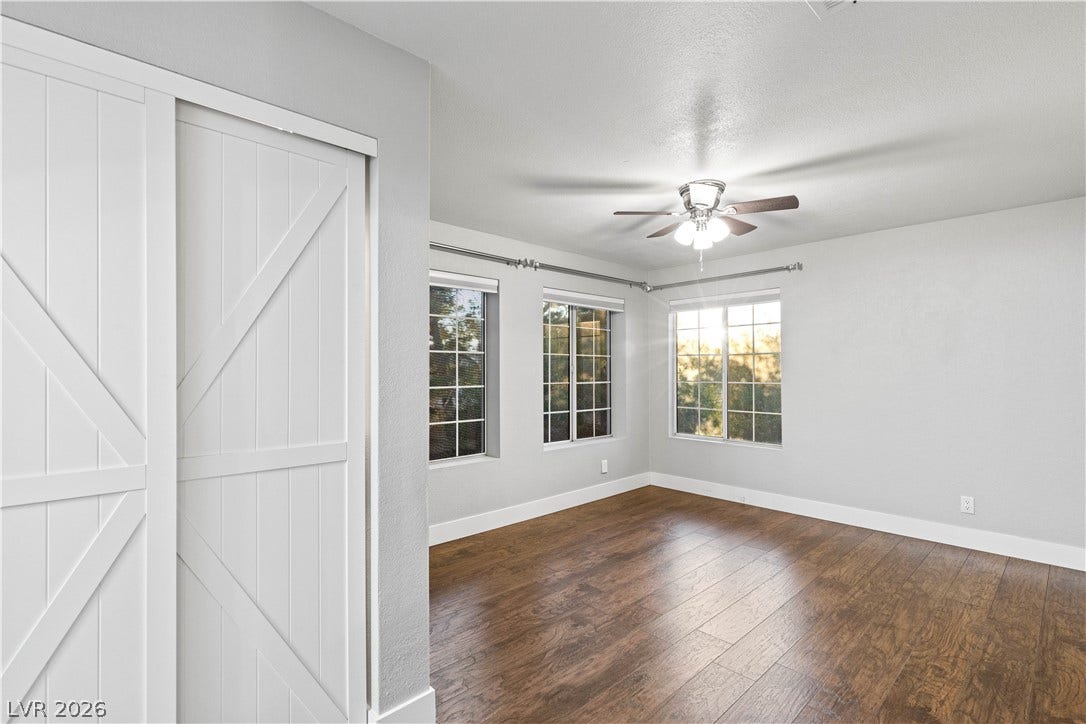 Gleaming hardwood floors and abundant natural light define this inviting, versatile living space.
