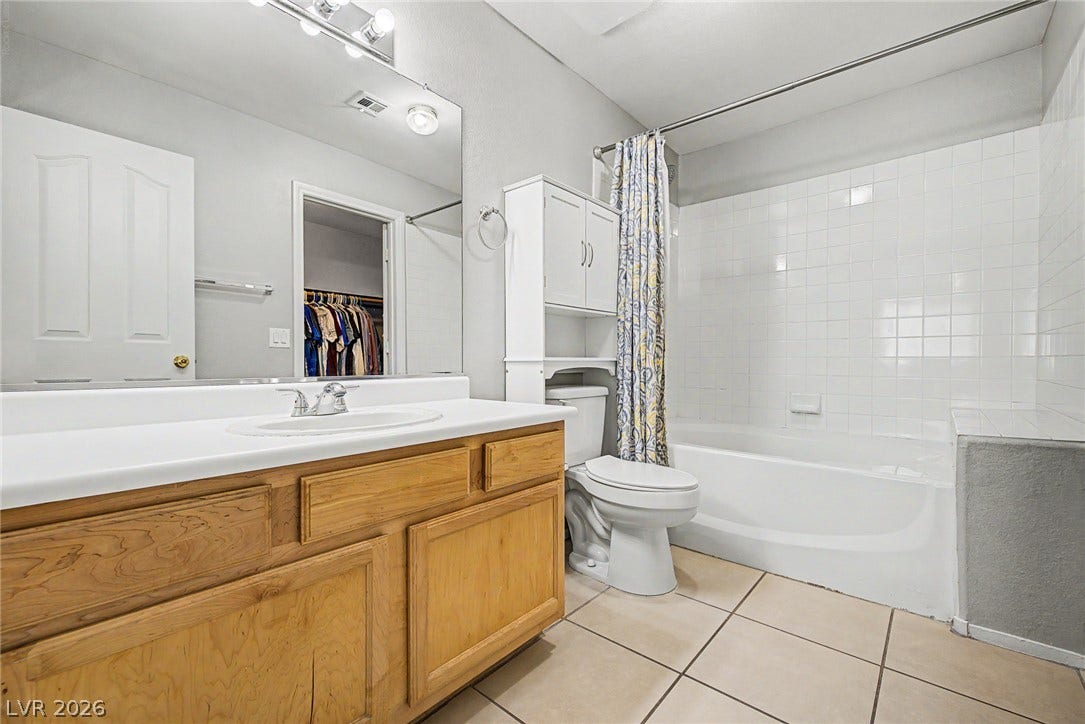 199 Winnsboro Street, Henderson, NV 89074 Tiled flooring and a classic wood vanity complete this functional bathroom space.