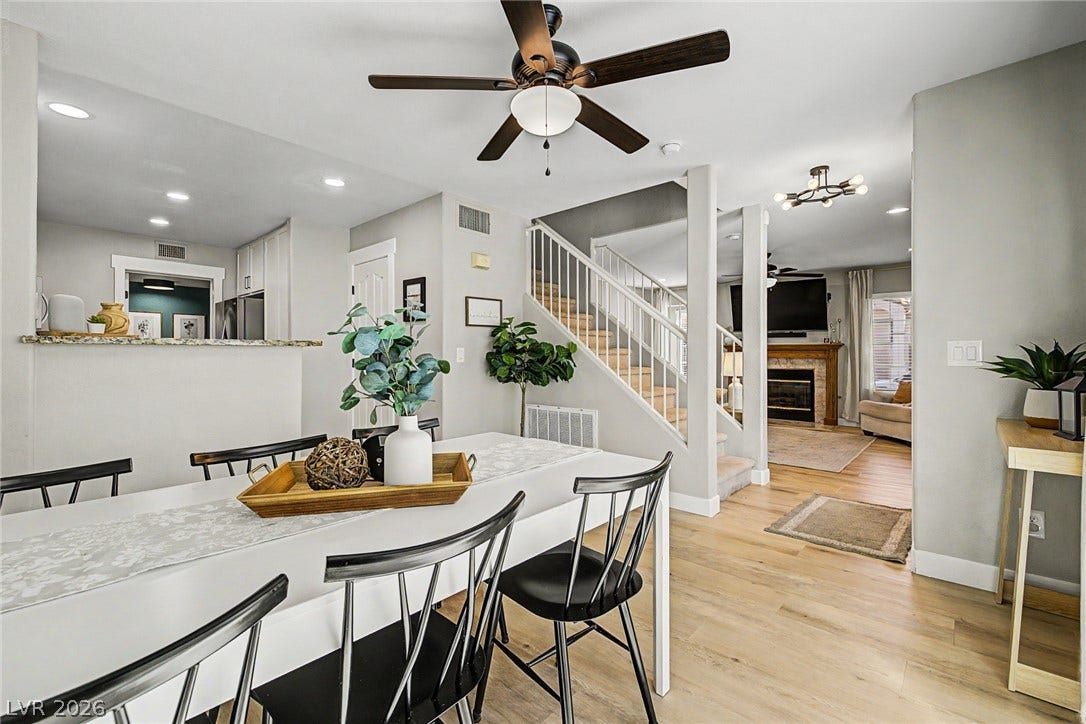 199 Winnsboro Street, Henderson, NV 89074 Hardwood floors and an open staircase define this light-filled dining space.