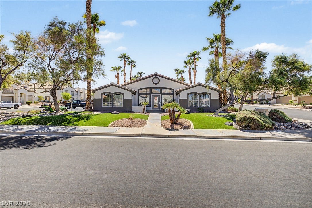 199 Winnsboro Street, Henderson, NV 89074 Mature palms and manicured landscaping frame the classic facade of this single-story desert home.