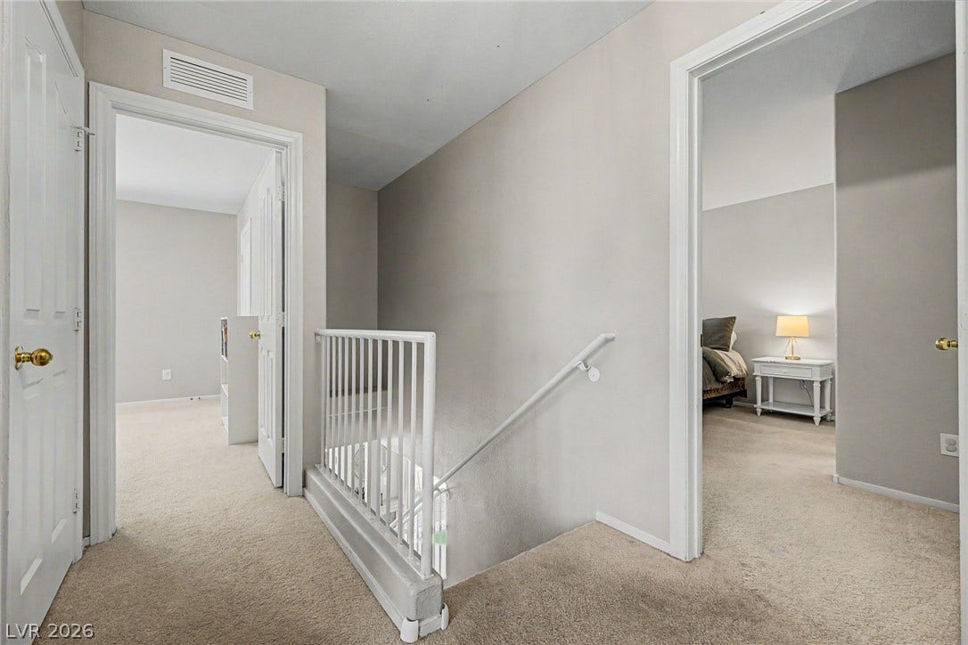 199 Winnsboro Street, Henderson, NV 89074 Plush carpeting lines the upper landing, offering seamless transitions to nearby bedrooms.