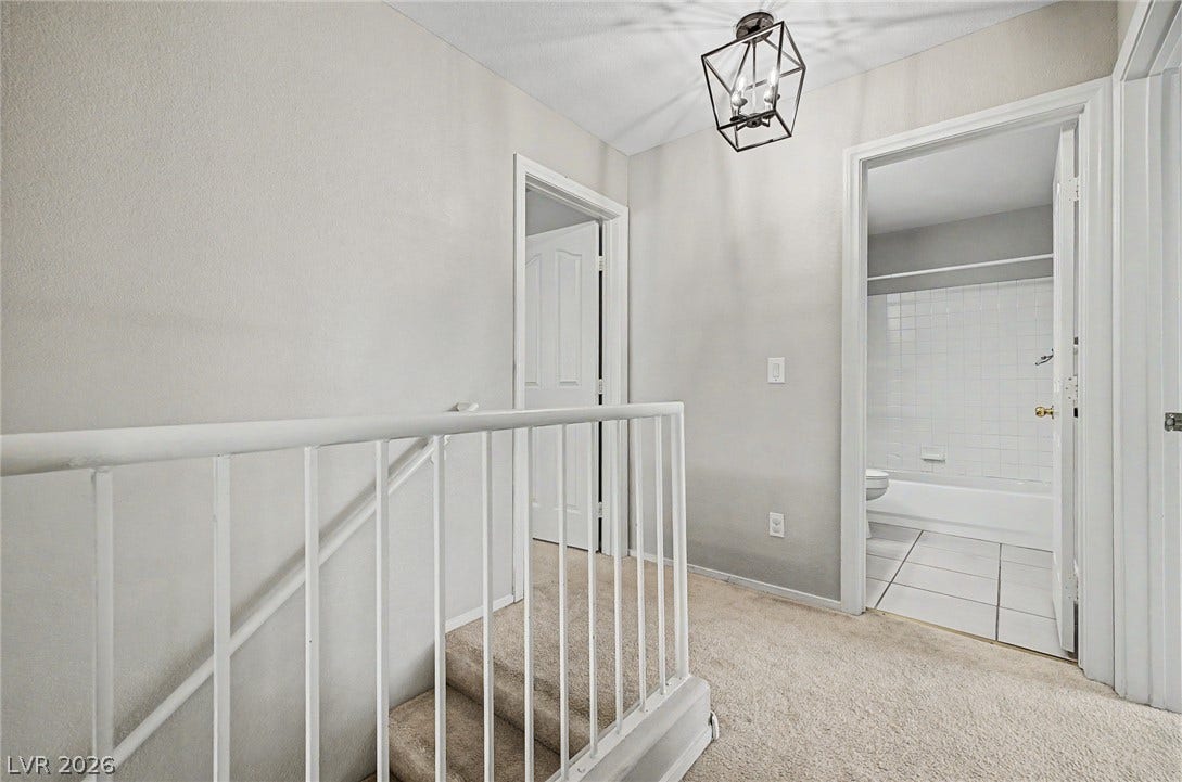 199 Winnsboro Street, Henderson, NV 89074 A spacious upper landing features soft carpeting and leads to adjacent bedrooms and bathrooms.