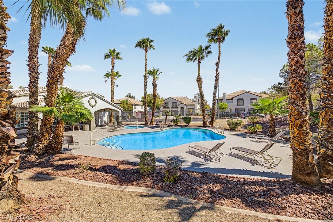 199 Winnsboro Street, Henderson, NV 89074 Towering palm trees frame a sparkling community swimming pool under clear desert skies.