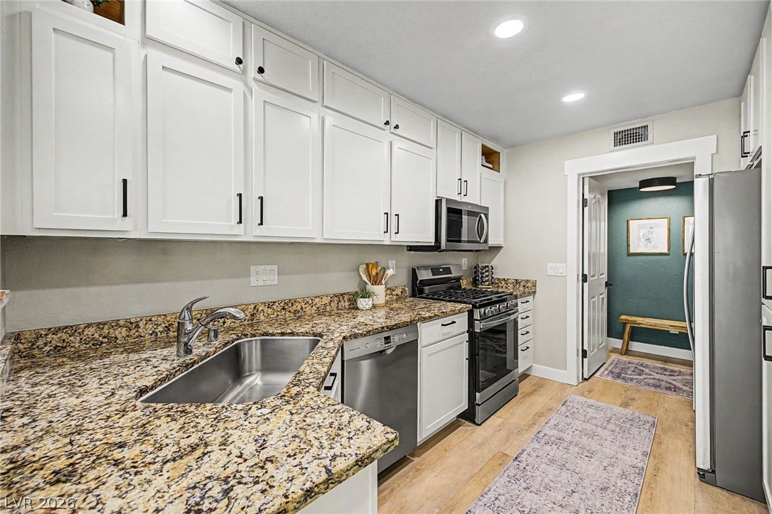 199 Winnsboro Street, Henderson, NV 89074 Polished granite countertops and classic white cabinetry define this highly functional culinary space.