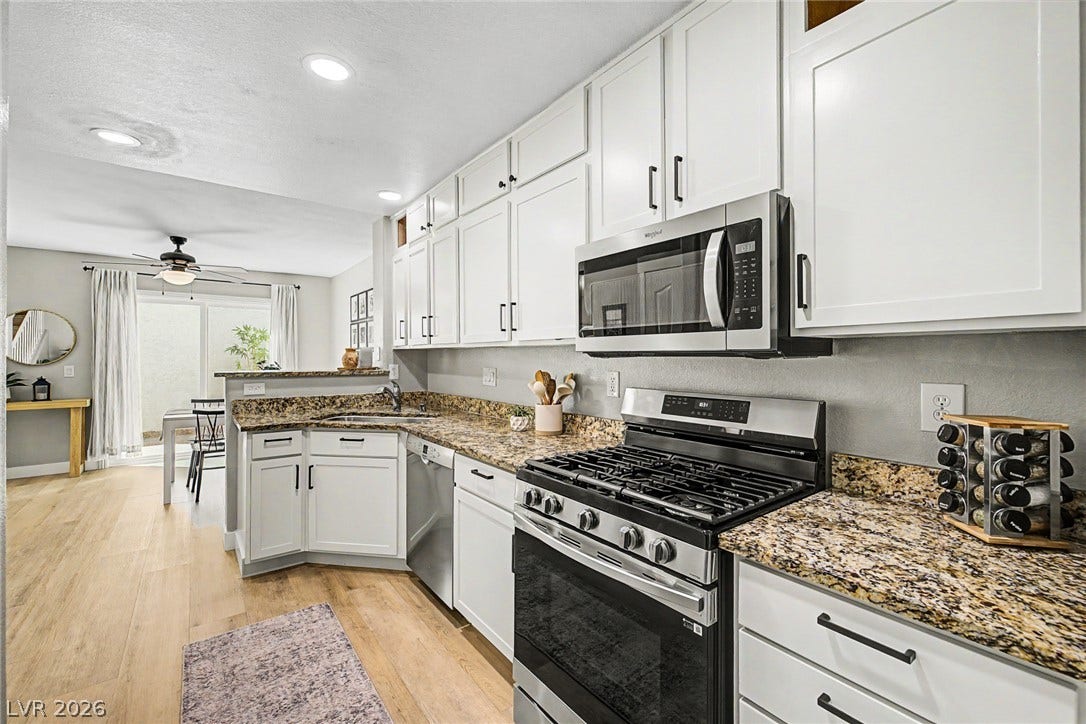 199 Winnsboro Street, Henderson, NV 89074 Gleaming stone countertops and modern appliances define this thoughtfully updated kitchen space.