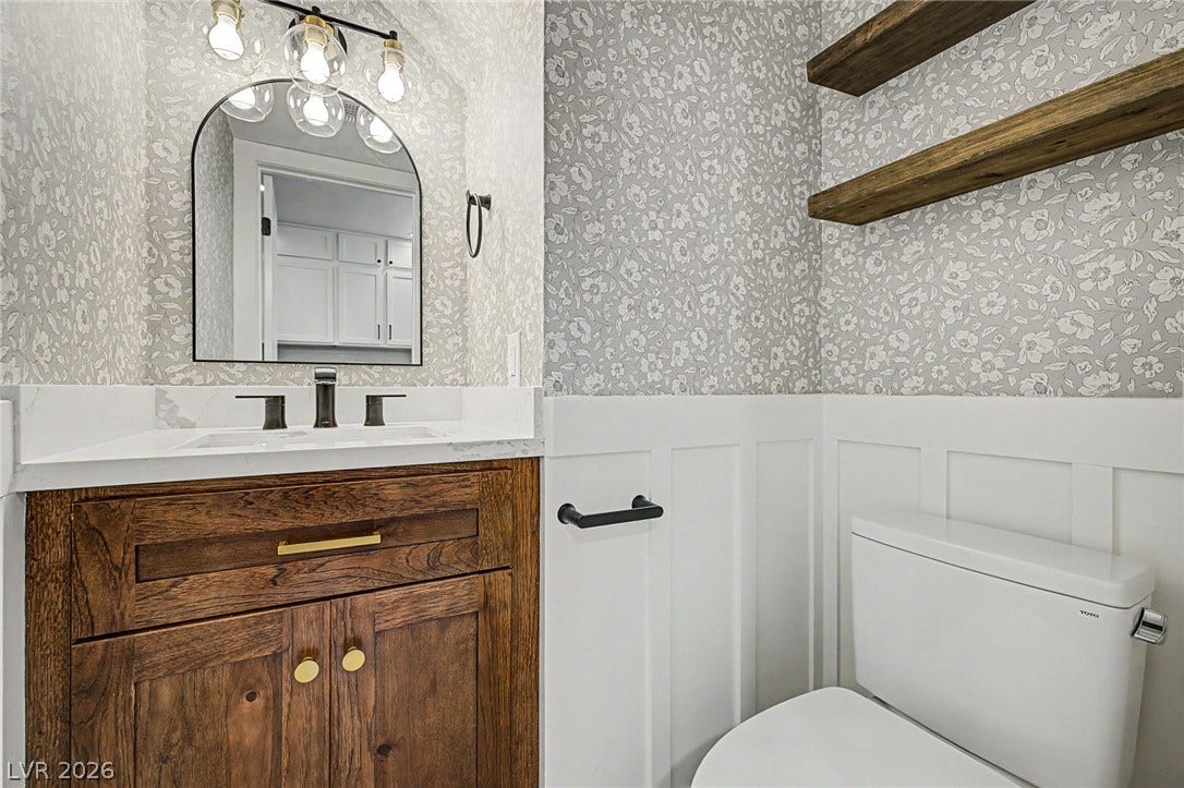 199 Winnsboro Street, Henderson, NV 89074 Board and batten wainscoting pairs with floral wallpaper and open wood shelves.