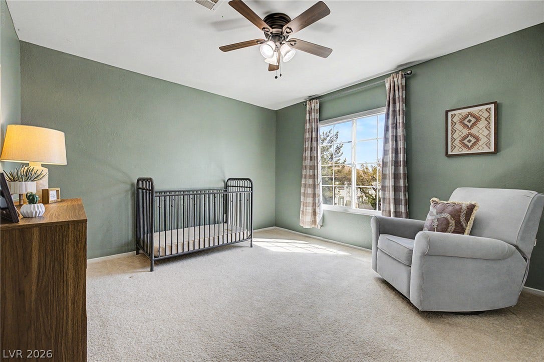 199 Winnsboro Street, Henderson, NV 89074 Natural light streams through a large window over comfortable carpeting in this inviting room.