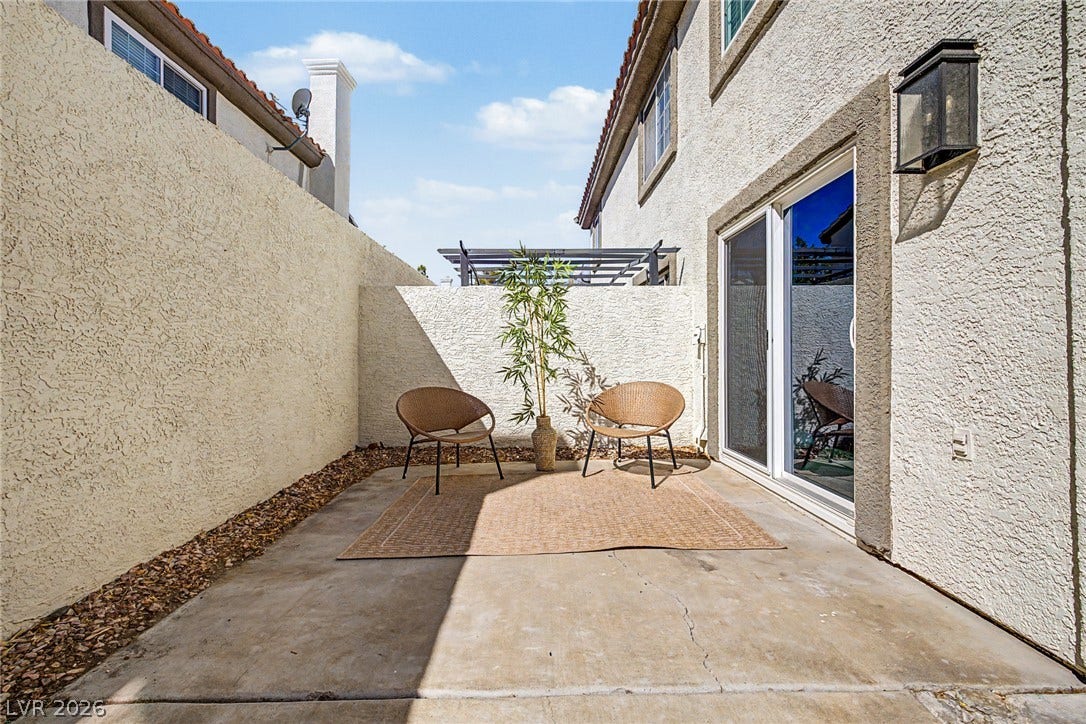 199 Winnsboro Street, Henderson, NV 89074 An enclosed concrete patio area provides a private outdoor retreat bordered by stucco walls.