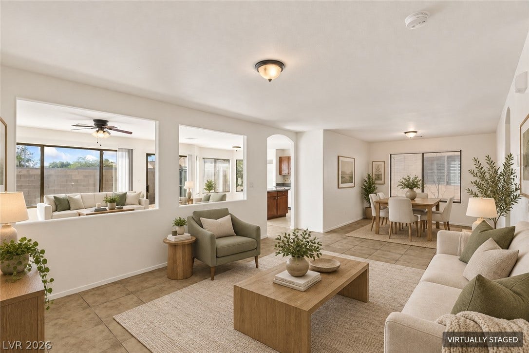 Tiled flooring flows through this open layout connecting the main living and dining areas.