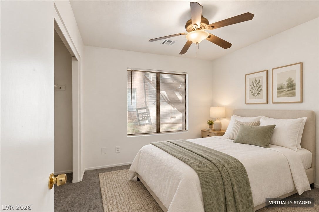 Plush carpeting and a wide window create a comfortable, inviting atmosphere.