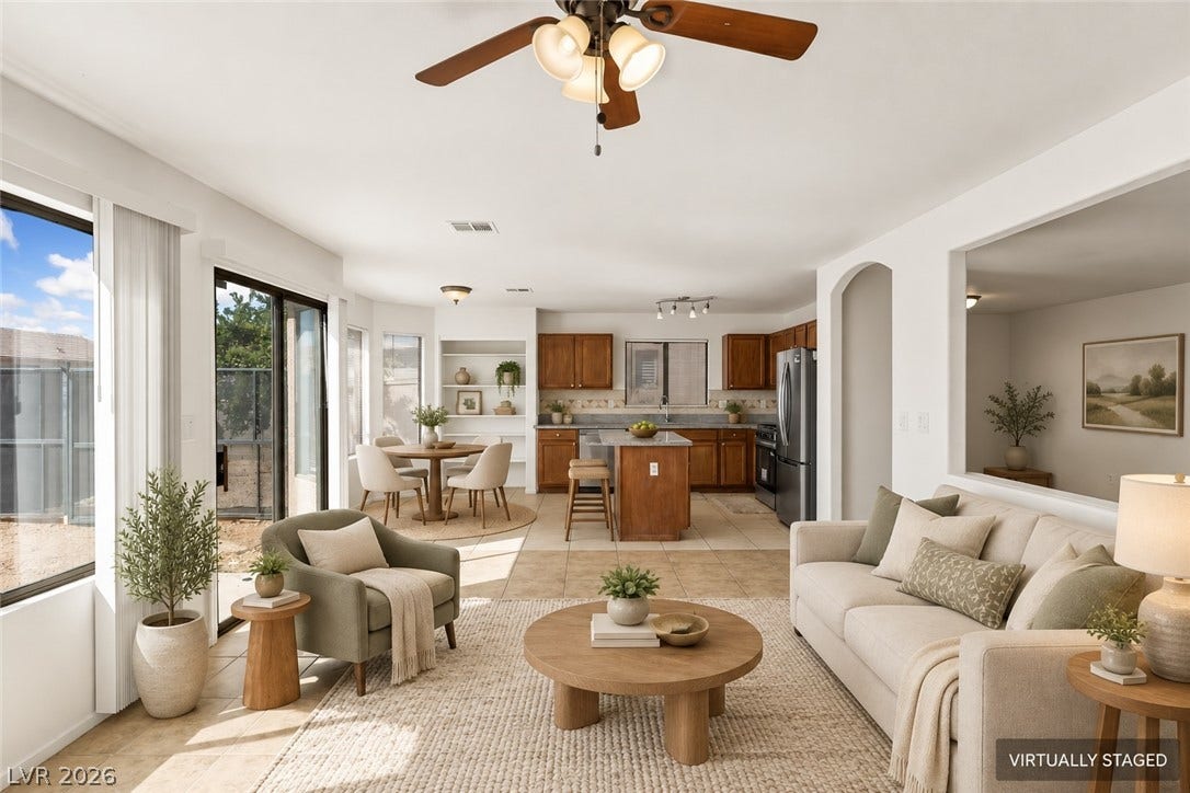Tile flooring and an open layout connect the inviting living room to the kitchen.