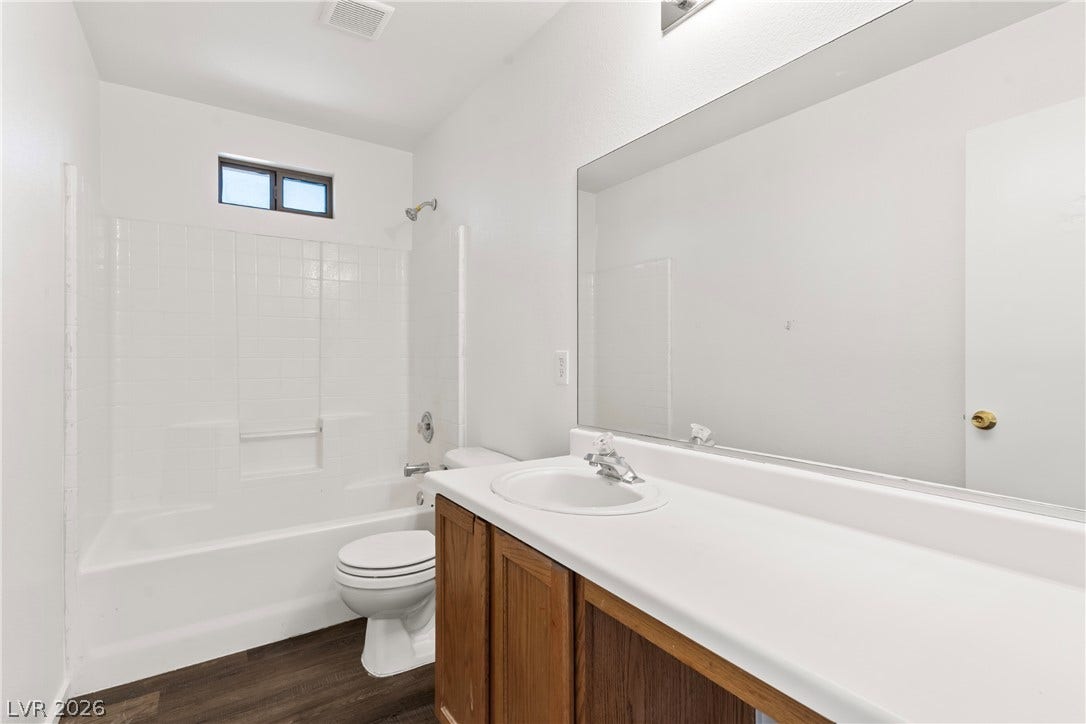 Clean lines and a spacious vanity define this functional guest bathroom.