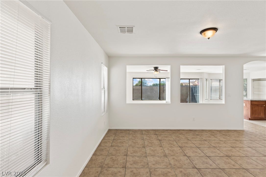 Tiled flooring and interior window cutouts enhance the open feel of this living space.