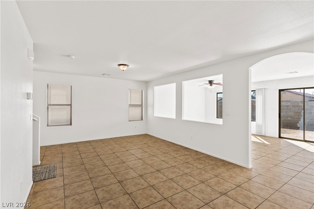 Tiled flooring and arched doorways define this open and versatile living space.
