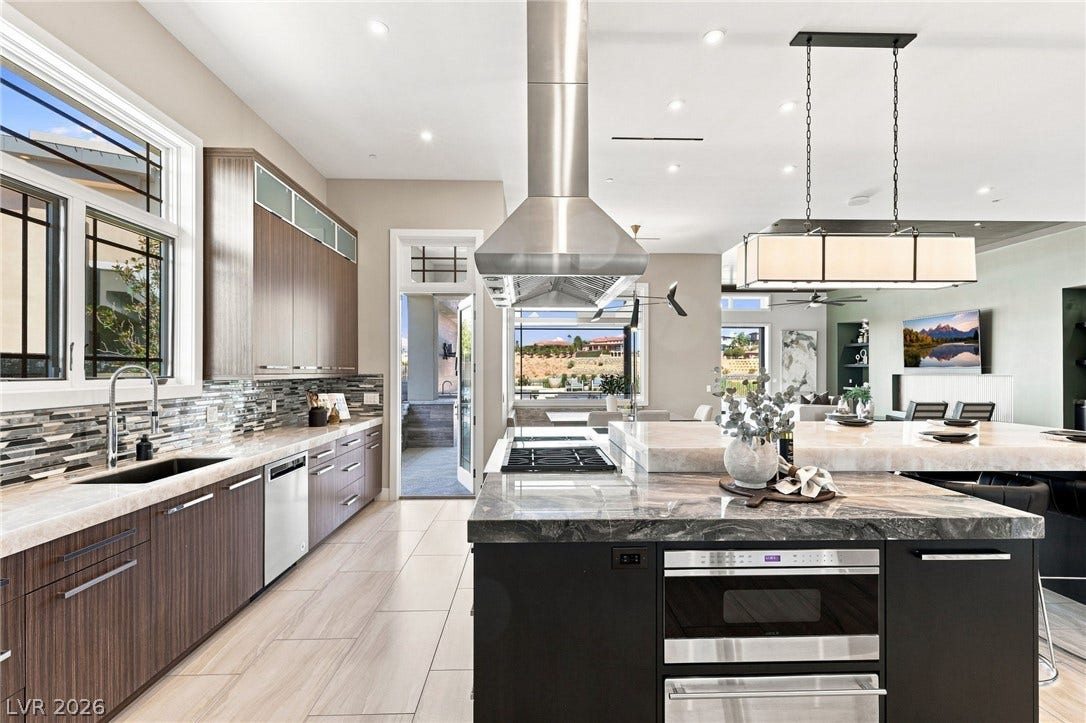 1376 Opal Valley Street, Henderson, NV 89052 Gleaming stone countertops and modern cabinetry define this spacious, open culinary space.