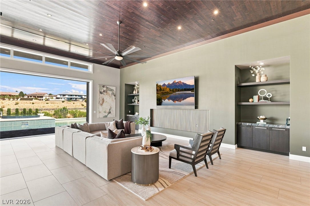 1376 Opal Valley Street, Henderson, NV 89052 Rich wood plank ceilings and seamless transitions to the patio define this modern living space.