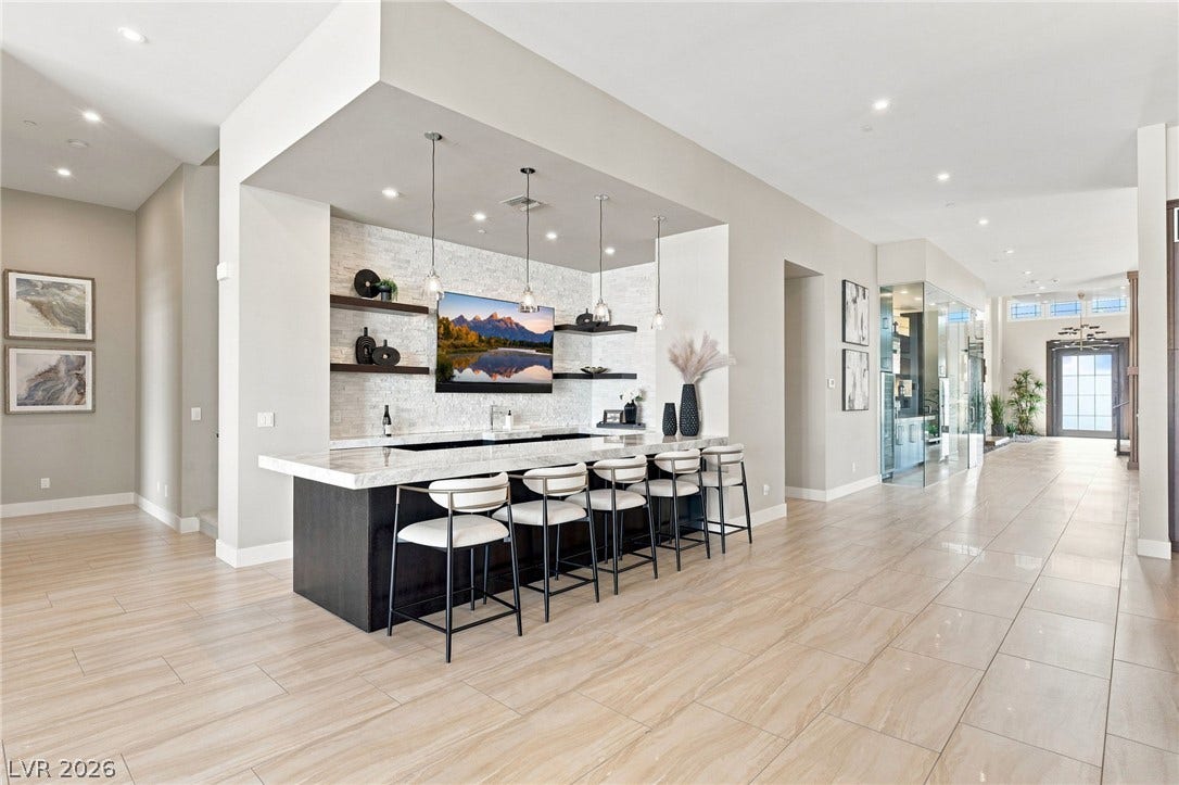 1376 Opal Valley Street, Henderson, NV 89052 Gleaming tile floors stretch past an elegant wet bar under a recessed ceiling.