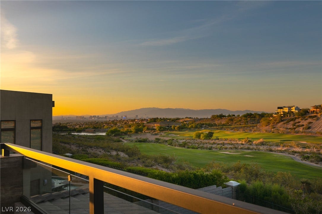 1376 Opal Valley Street, Henderson, NV 89052 Distant city skylines and mountain ranges frame the lush green golf course views below.