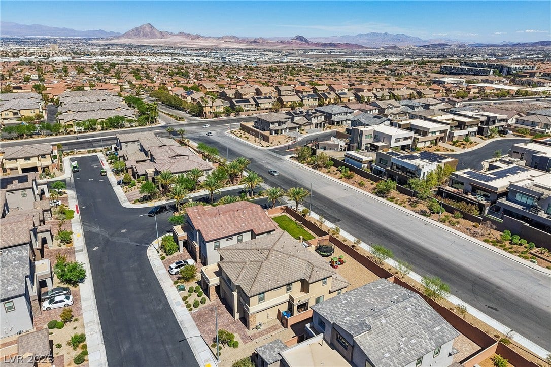 194 Viento Ridge Street, Henderson, NV 89012 Distant mountains frame a sweeping aerial perspective of this modern suburban neighborhood.