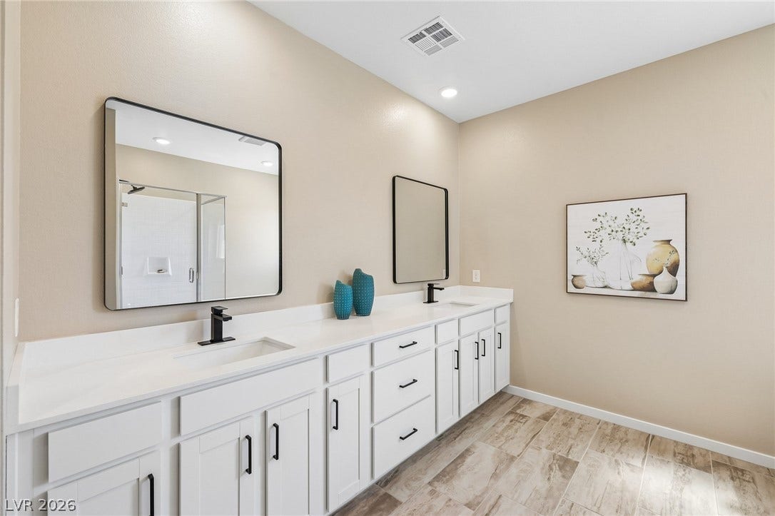 194 Viento Ridge Street, Henderson, NV 89012 Clean lines and modern tile floors define this sleek double vanity bathroom space.