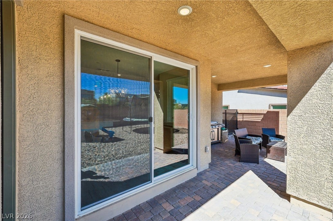 194 Viento Ridge Street, Henderson, NV 89012 An inviting covered patio features textured stucco walls and classic paver flooring.
