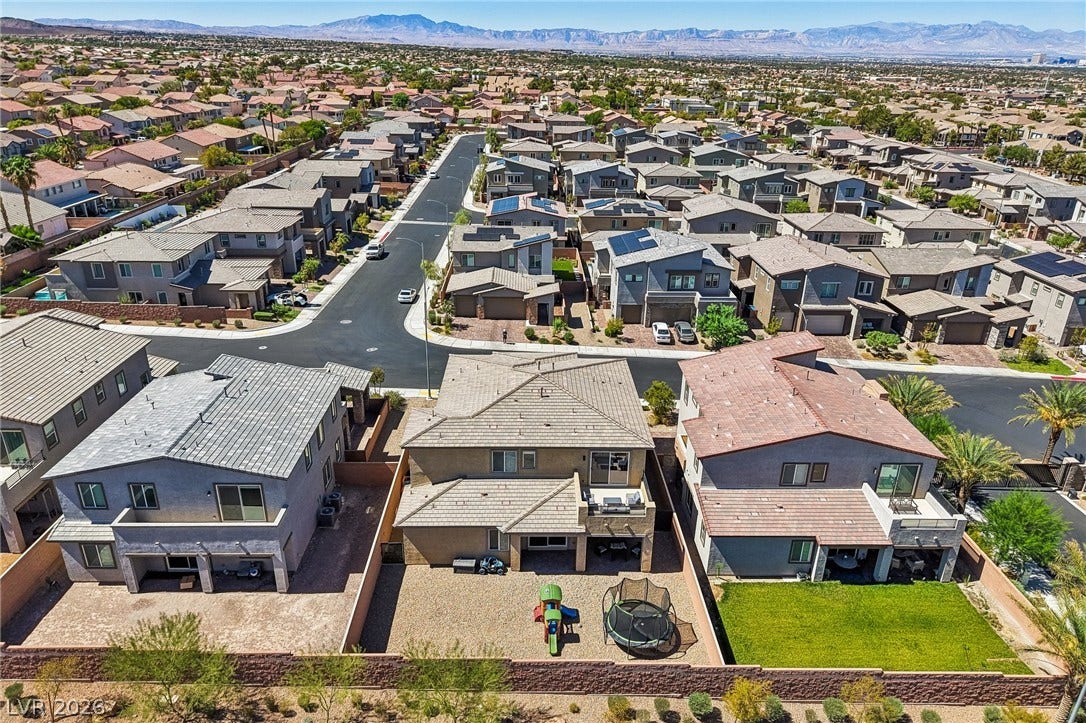 194 Viento Ridge Street, Henderson, NV 89012 Distant mountains frame a sprawling suburban neighborhood of modern multi-level homes.