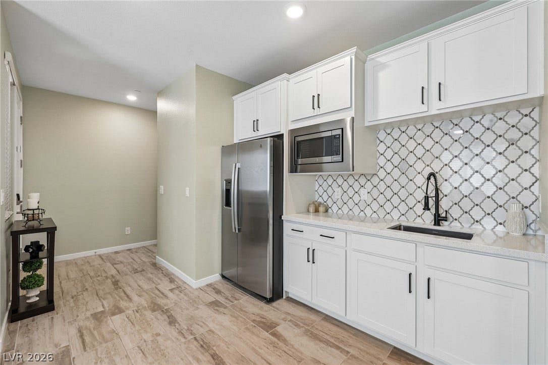 194 Viento Ridge Street, Henderson, NV 89012 Streamlined cabinetry and patterned tile accents define this modern culinary workspace.
